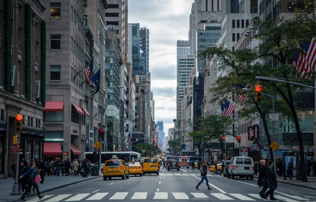 city-street-photo-378570 Vibrant street view of New York City with pedestrians, yellow cabs, and skyscrapers.