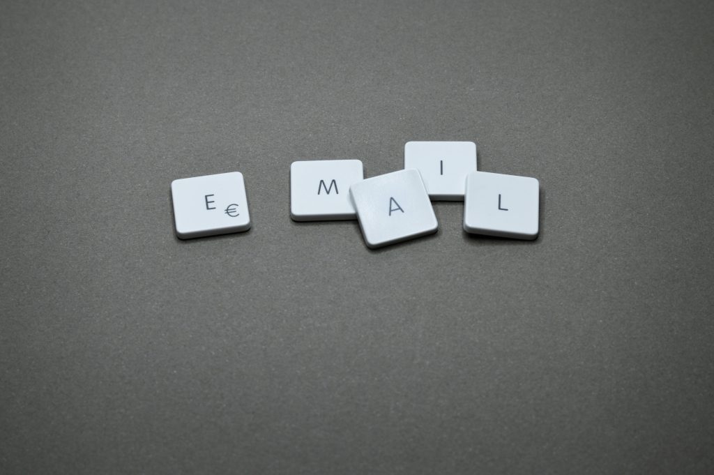 pexels photo 1591062 1591062 Close-up of the word 'email' formed with letter tiles on a gray surface.