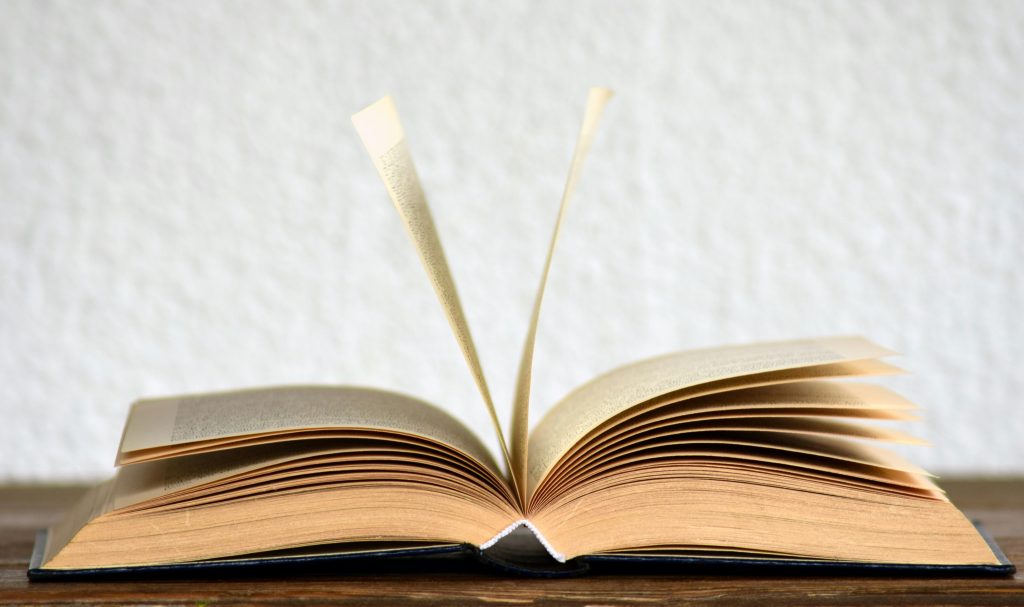 pexels photo 415071 415071 Close-up image of an open book with pages turning, creating a dynamic visual.